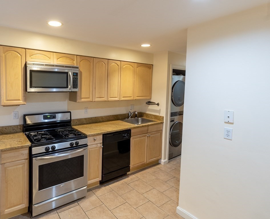 55 East Concord Street, Unit 1 Boston, MA 02118 - Photo 14 of 16 a kitchen with granite countertop a stove and a microwave