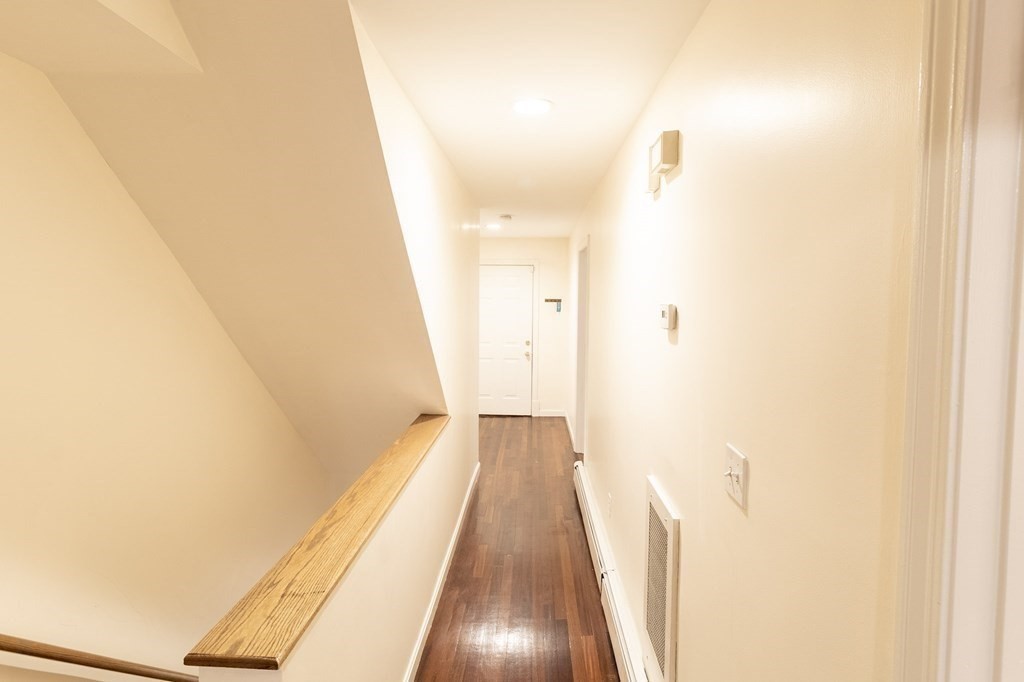 55 East Concord Street, Unit 1 Boston, MA 02118 - Photo 3 of 16 a view of a hallway with wooden floor and a bathroom