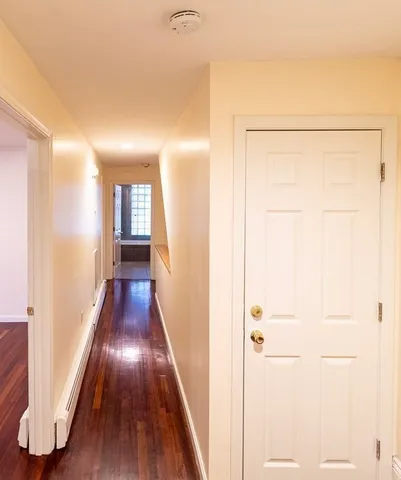 a view of hallway with wooden floor