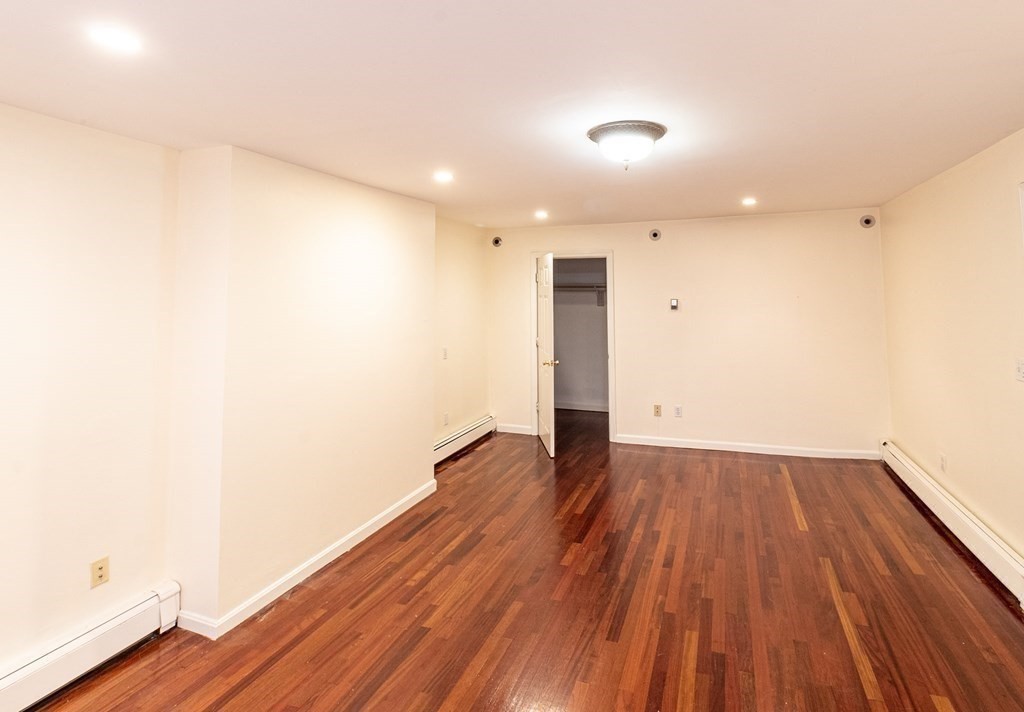55 East Concord Street, Unit 1 Boston, MA 02118 - Photo 5 of 16 a view of an empty room with wooden floor