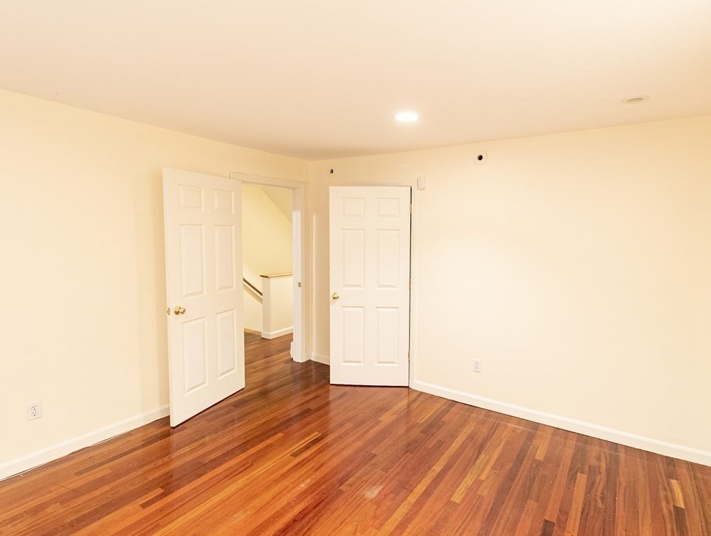 55 East Concord Street, Unit 1 Boston, MA 02118 - Photo 8 of 16 a view of an empty room with wooden floor and a window