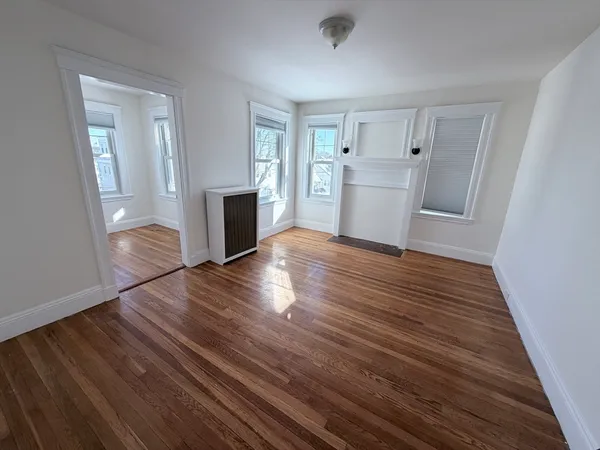 wooden floor in an empty room with a fireplace