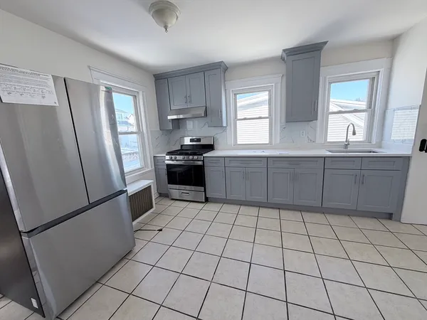 a kitchen with stainless steel appliances a refrigerator sink and cabinets