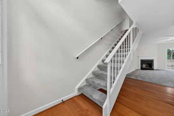 a view of entryway and hall with wooden floor
