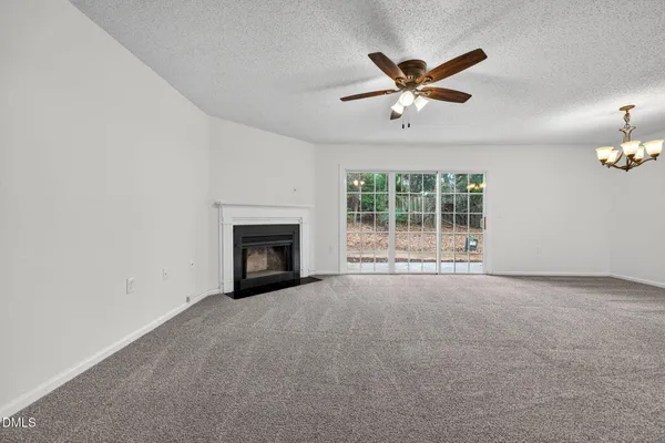 an empty room with fan and windows
