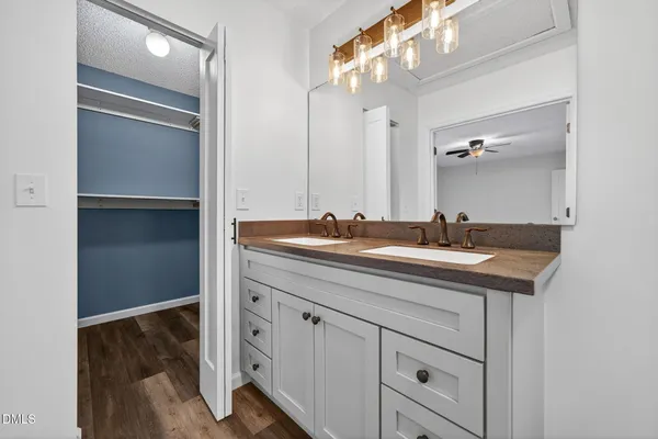 a bathroom with a sink vanity and a mirror