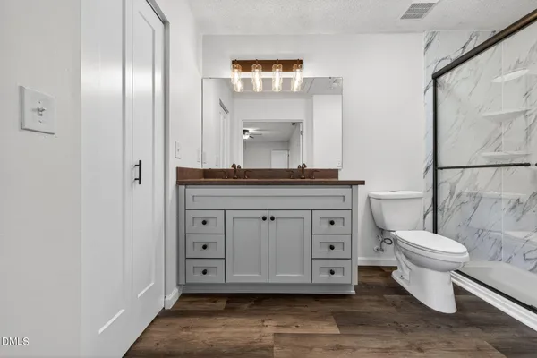 a bathroom with a toilet a sink and mirror