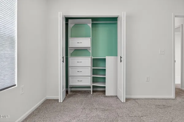 a view of an empty room and closet area