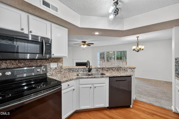 a kitchen with a sink stove and microwave