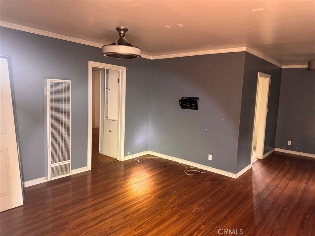 925 East Appleton Street, Unit 4 Long Beach, CA 90802 - Photo 2 of 9 a view of an empty room with wooden floor and a window