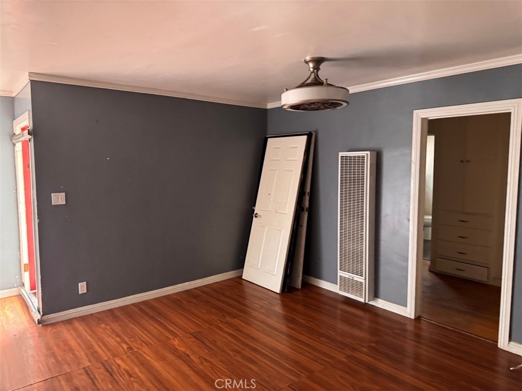 925 East Appleton Street, Unit 4 Long Beach, CA 90802 - Photo 3 of 9 wooden floor in an empty room with a window