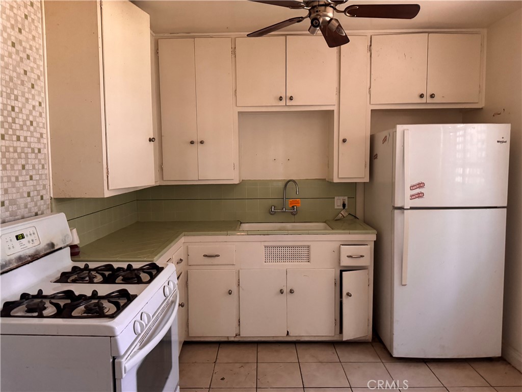 925 East Appleton Street, Unit 4 Long Beach, CA 90802 - Photo 4 of 9 a kitchen with a stove and white cabinets