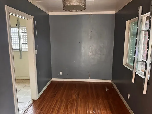 a view of a room with wooden floor and a window