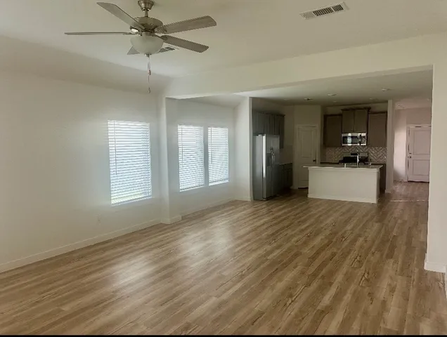 wooden floor in an empty room with a window