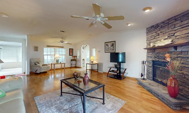 a living room with furniture and wooden floor