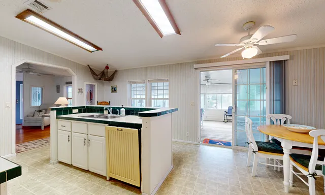 a kitchen with stainless steel appliances kitchen island a sink stove and refrigerator