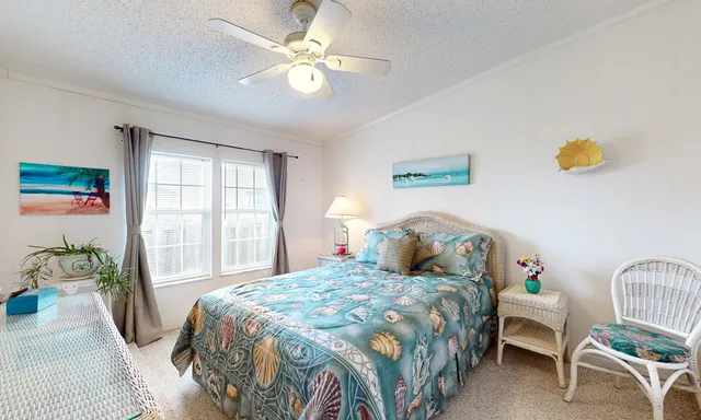 a bedroom with a bed chandelier and a window