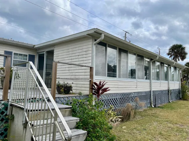a potted plant sitting on the side of a wooden building