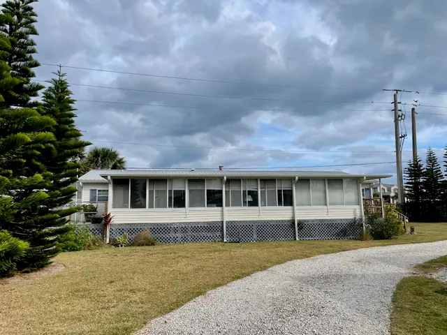 a house view with a sitting space and garden