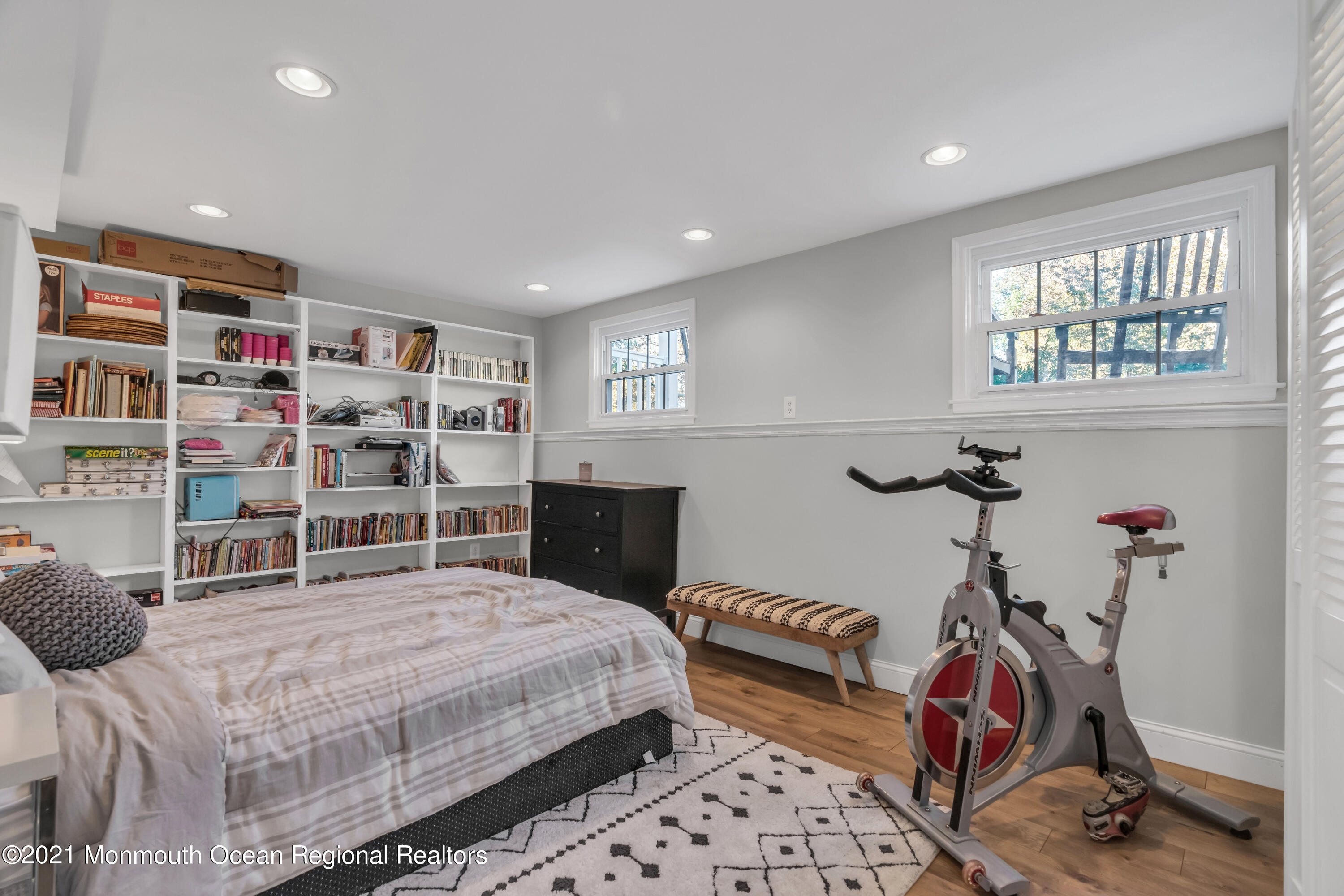 6 Spring Valley Drive Holmdel, NJ 07733 - Photo 20 of 32 a bedroom with a bed a standing and a bookshelf