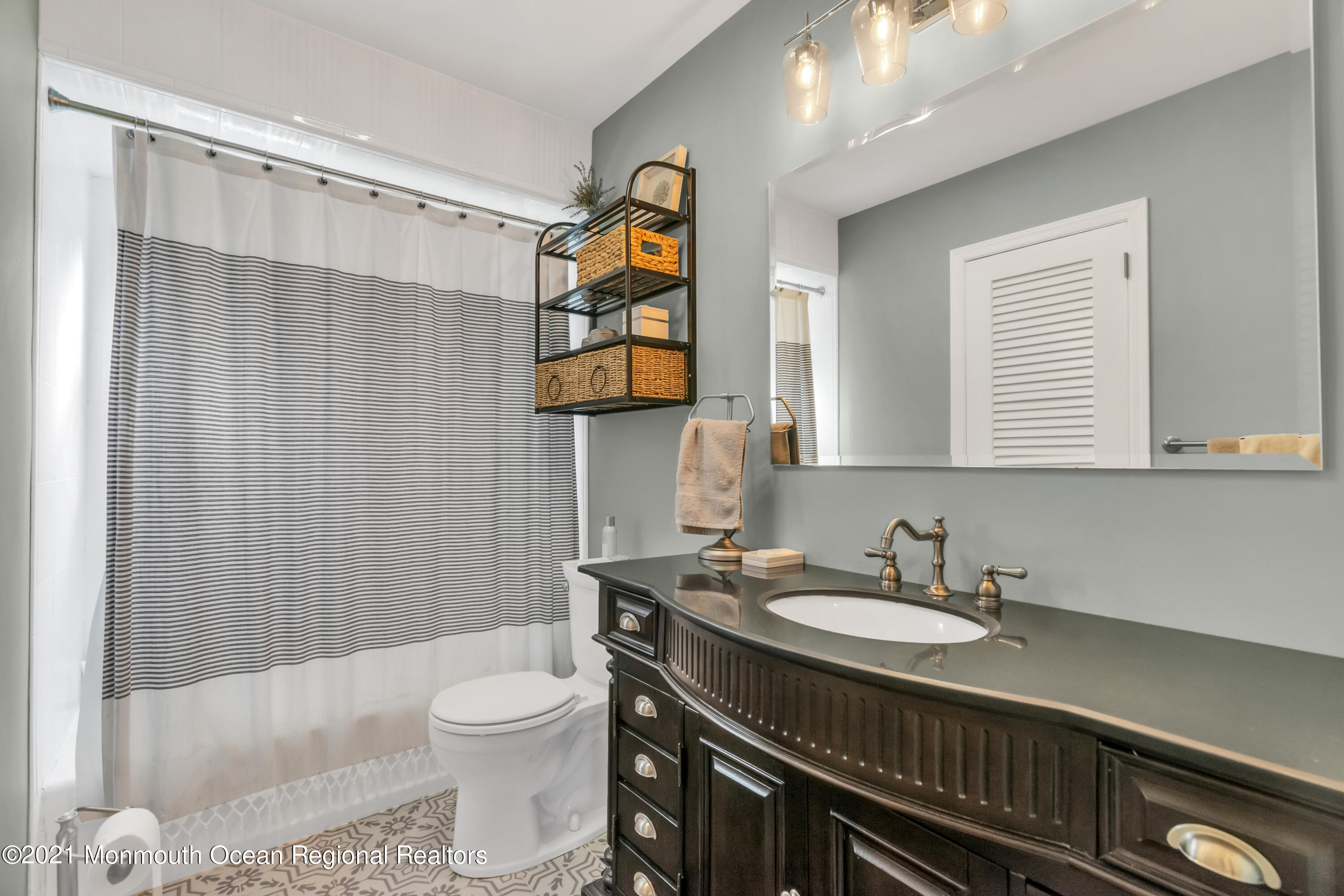 6 Spring Valley Drive Holmdel, NJ 07733 - Photo 21 of 32 a bathroom with a sink toilet a mirror and shower