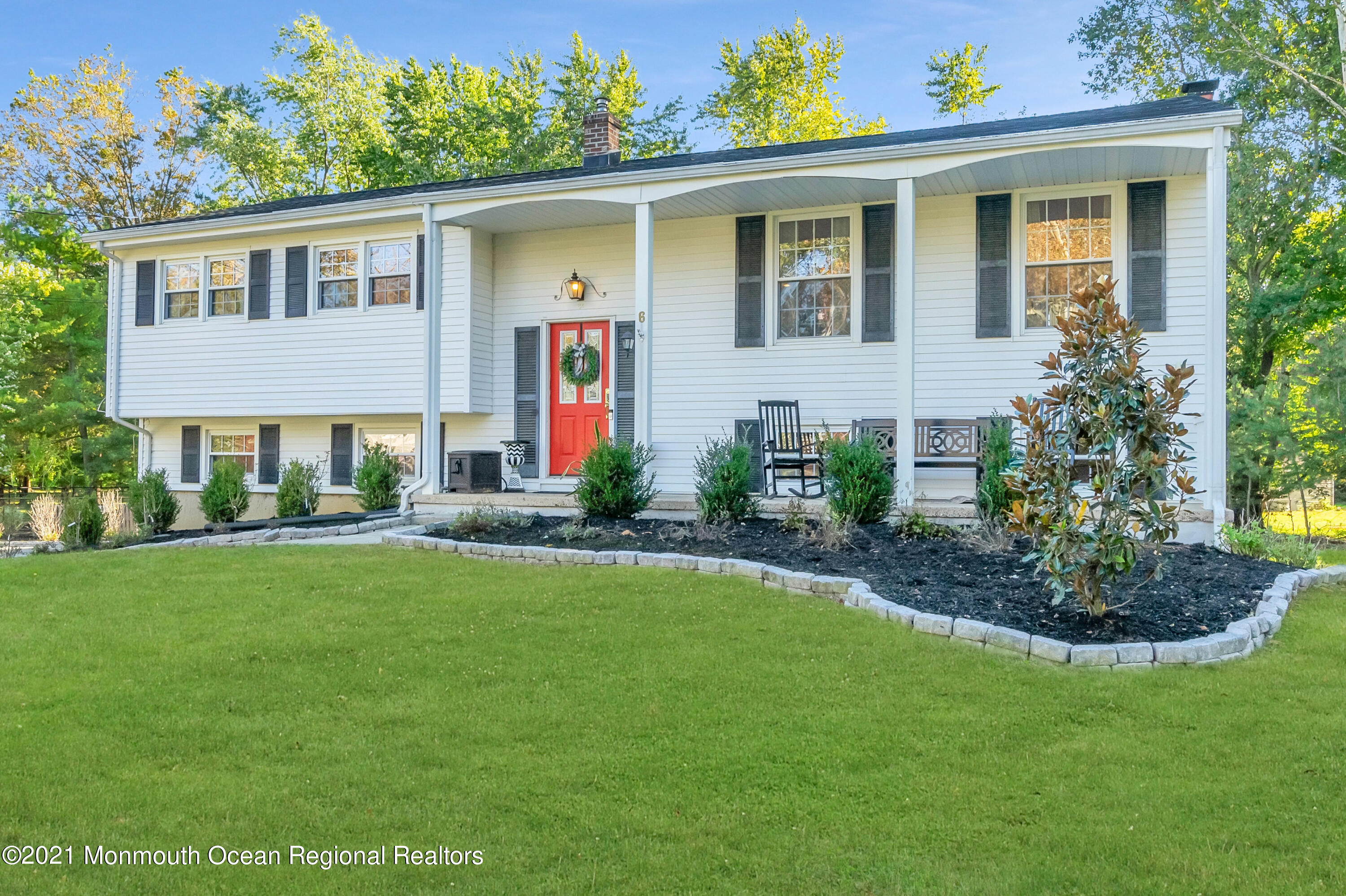 6 Spring Valley Drive Holmdel, NJ 07733 - Photo 30 of 32 a front view of a house with a yard and potted plants