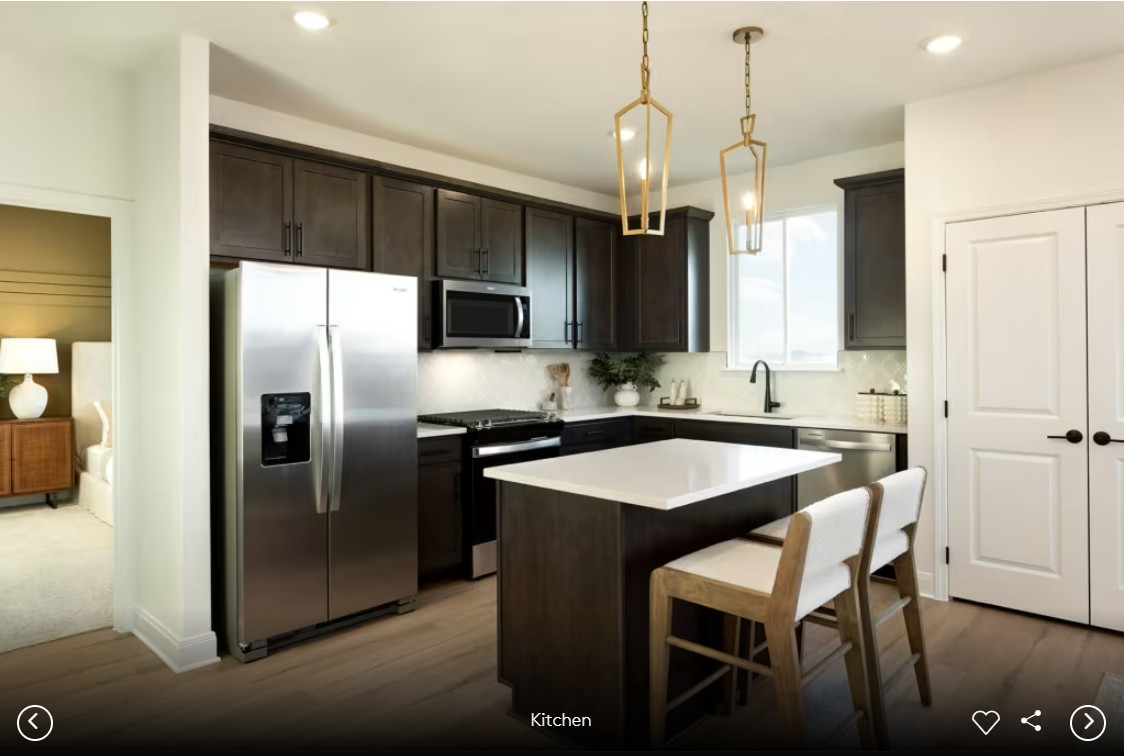 624 Rubber Tree Way Buda, TX 78610 - Photo 4 of 12 a kitchen with stainless steel appliances granite countertop a sink a stove a refrigerator and island