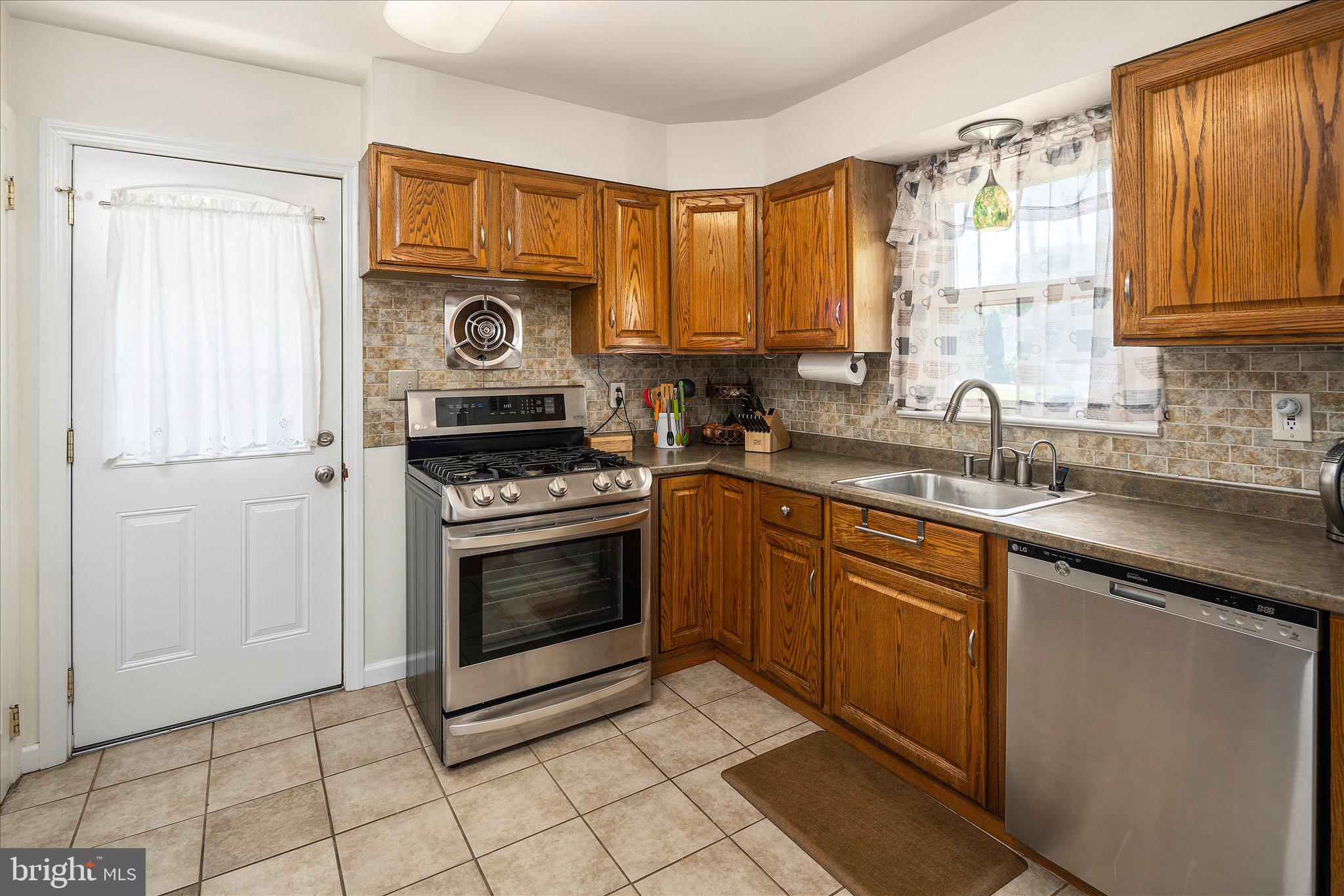 3 Heights Terrace Hamilton, NJ 08620 - Photo 9 of 30 a kitchen with stainless steel appliances granite countertop a stove a sink and a microwave