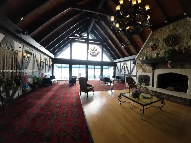 a living room with patio furniture and a fireplace