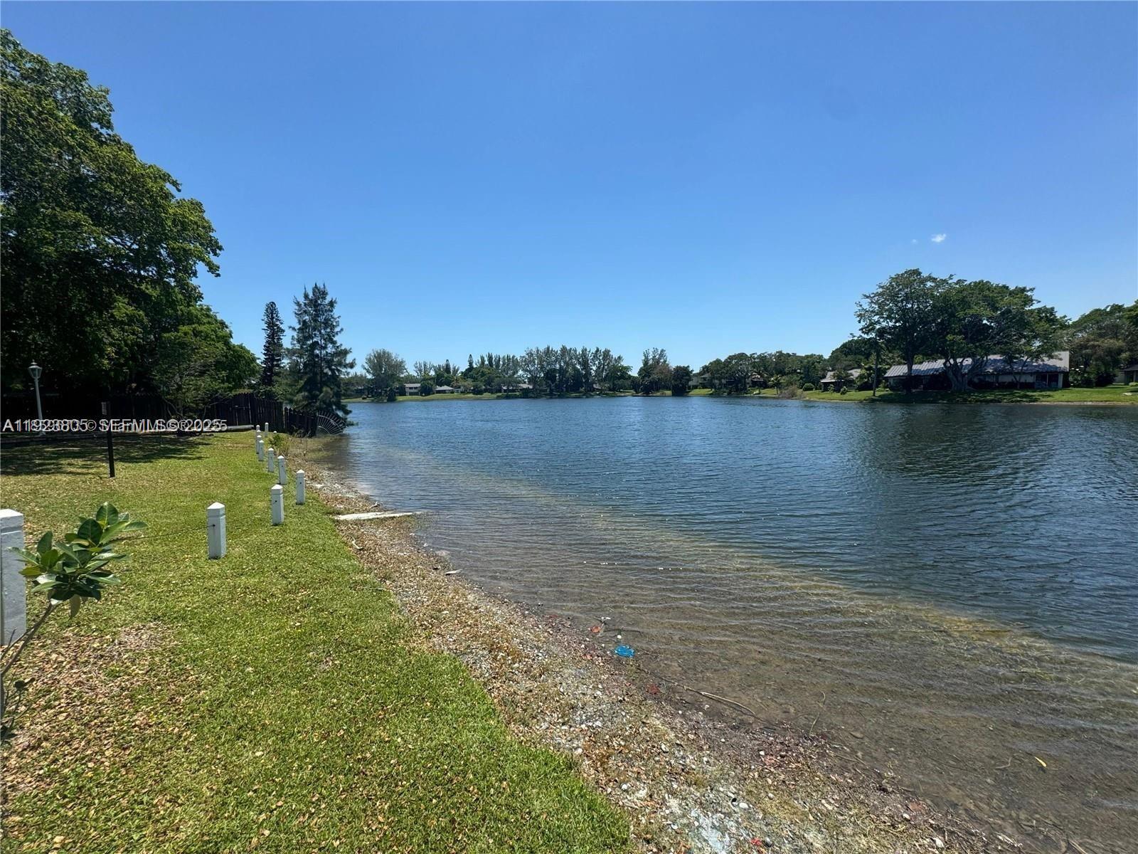 3720 Inverrary Drive, Unit 1S Lauderhill, FL 33319 - Photo 9 of 25 a view of a lake with houses in the back