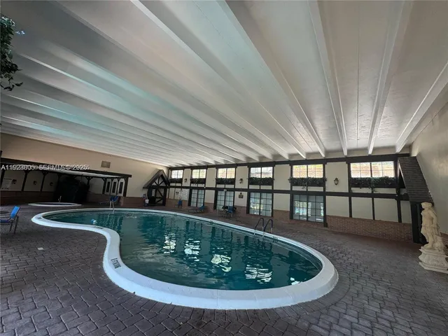 a room with lots of potted plants on table and chairs