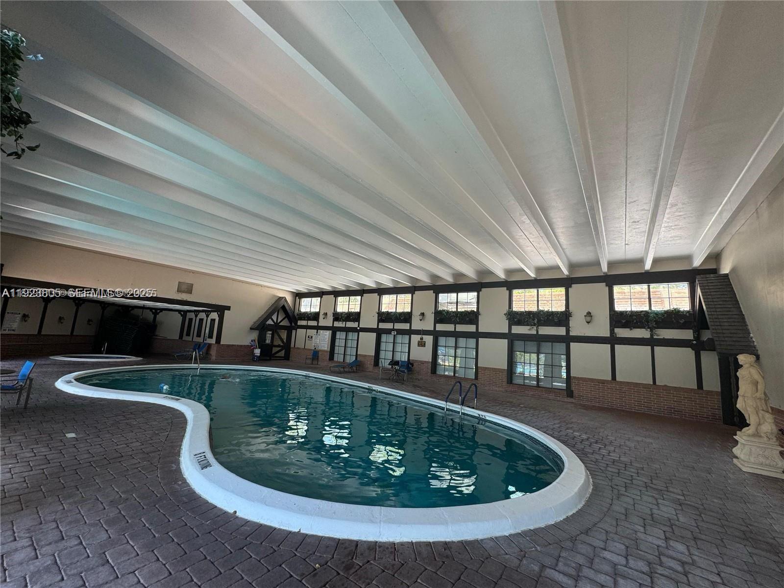 3720 Inverrary Drive, Unit 1S Lauderhill, FL 33319 - Photo 10 of 25 a room with lots of potted plants on table and chairs