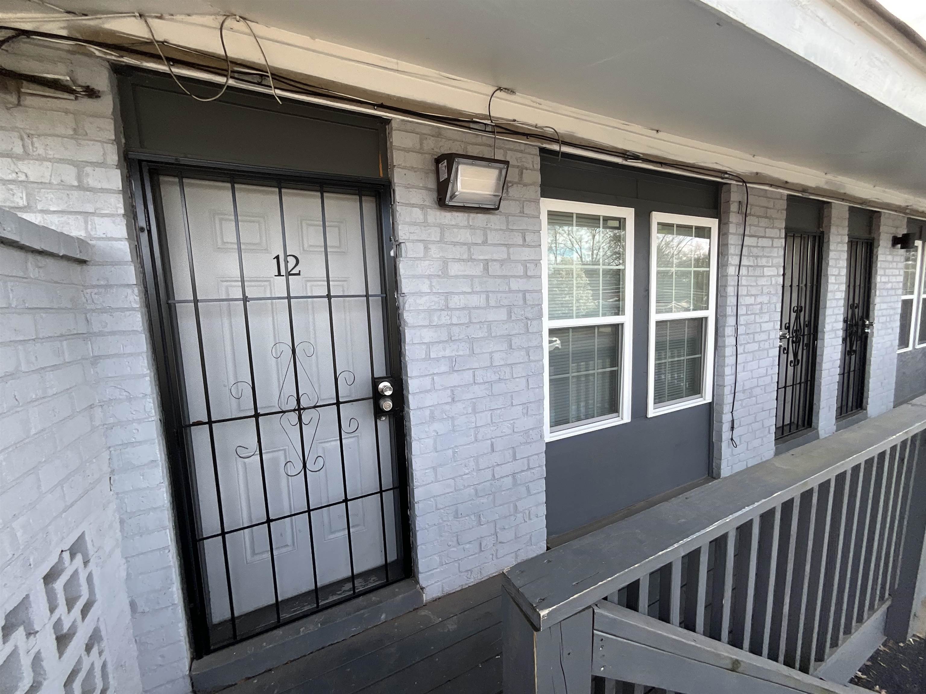 4455 Macon Road, Unit 12 Memphis, TN 38122 - Photo 1 of 7 View of exterior entry with brick siding and covered porch