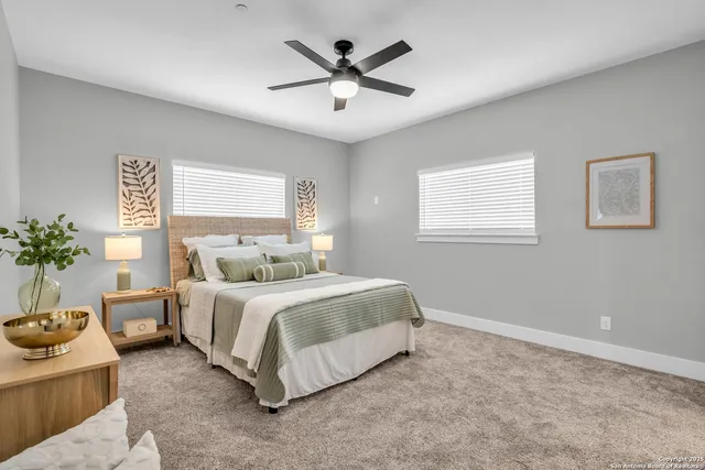 a spacious bedroom with a bed and a window