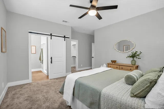 a bedroom with a bed and a chandelier