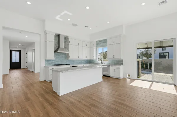 a kitchen with a sink cabinets and wooden floor