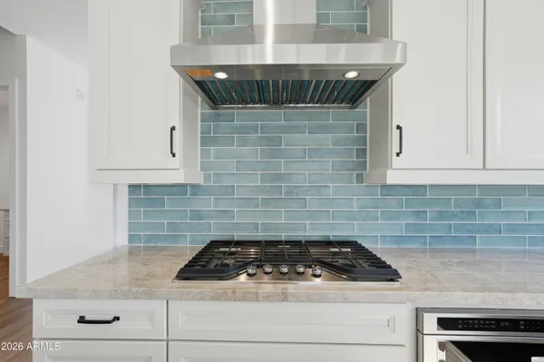 a stove top oven sitting inside of a kitchen