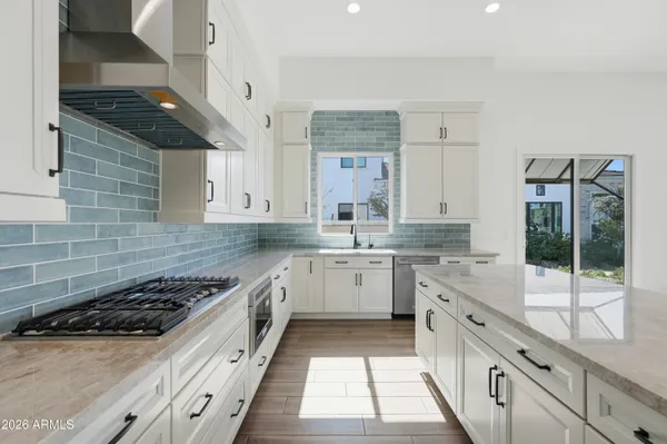 a kitchen with stainless steel appliances granite countertop a stove sink and cabinets
