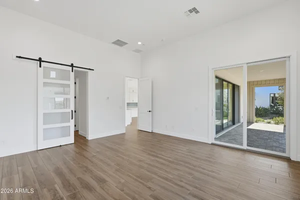 a view of an empty room with wooden floor