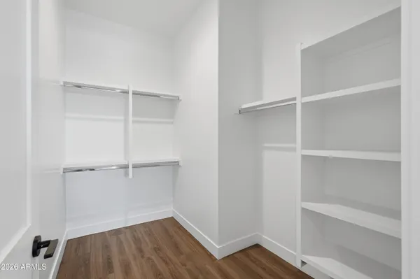 a view of walk in closet with empty racks