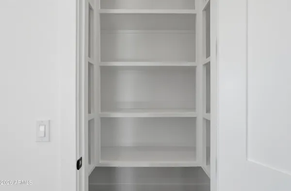 a view of walk in closet with wooden floor