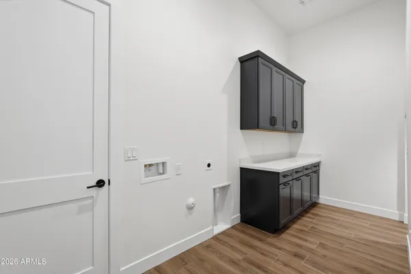 an empty room with wooden floor and stairs