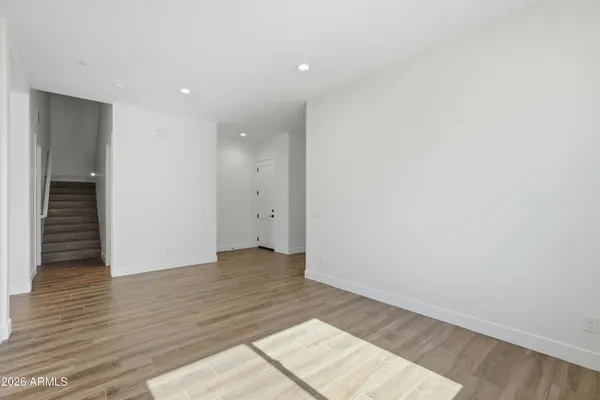 a view of an empty room with wooden floor