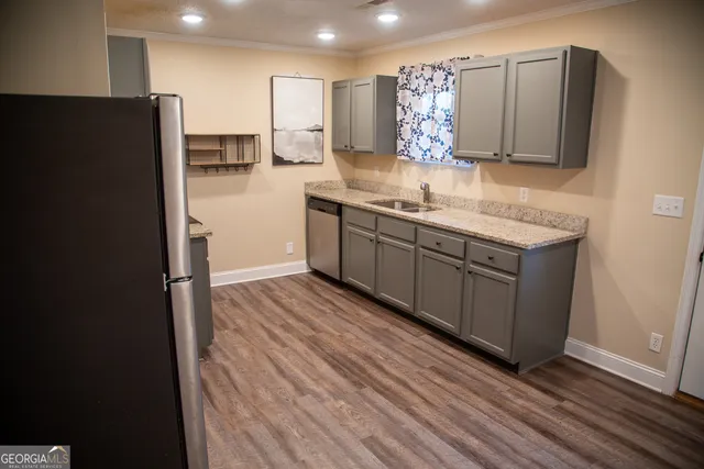 a kitchen with stainless steel appliances granite countertop a refrigerator and a sink