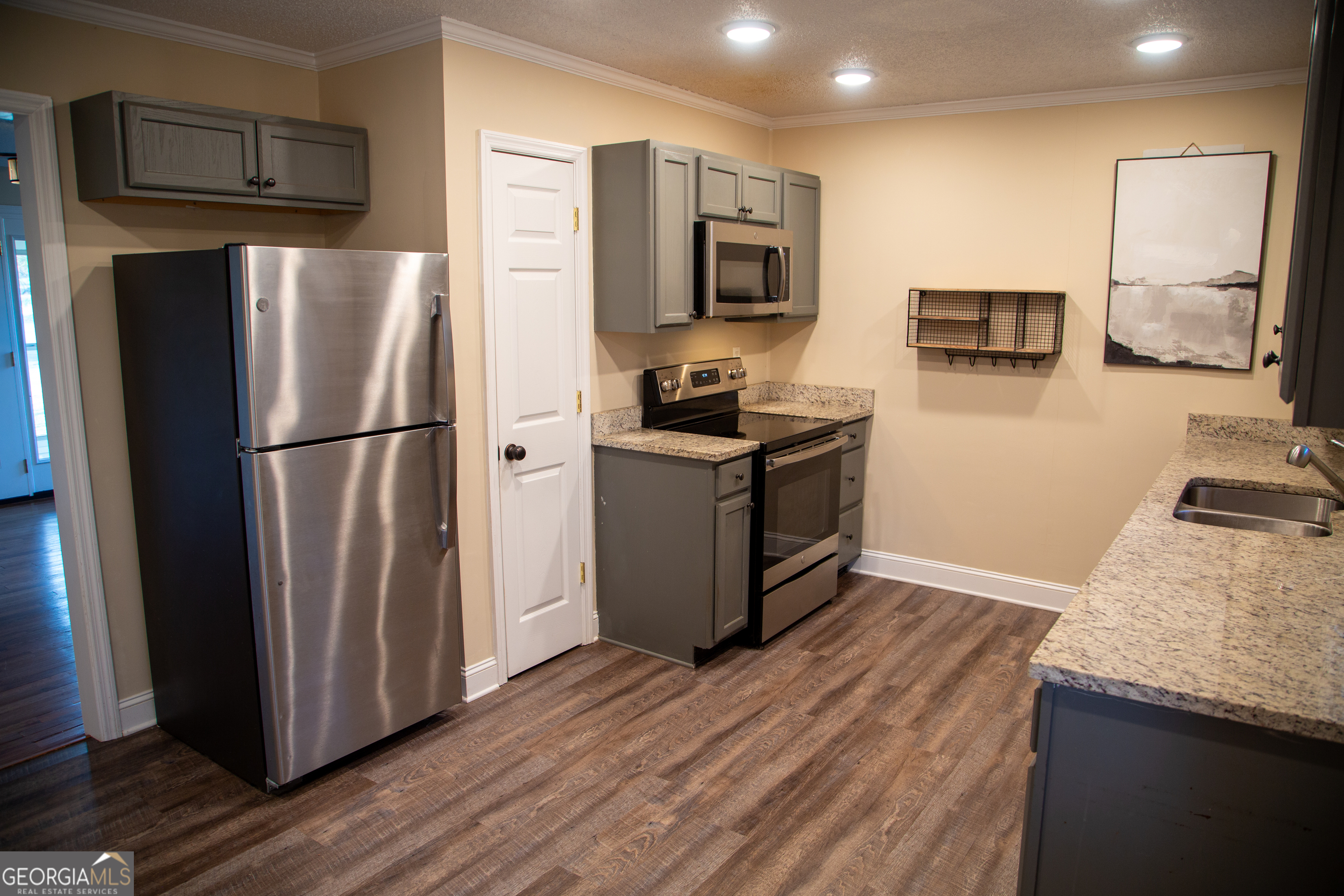 307 South Duke Street LaFayette, GA 30728 - Photo 12 of 23 a kitchen with stainless steel appliances granite countertop a refrigerator stove and microwave