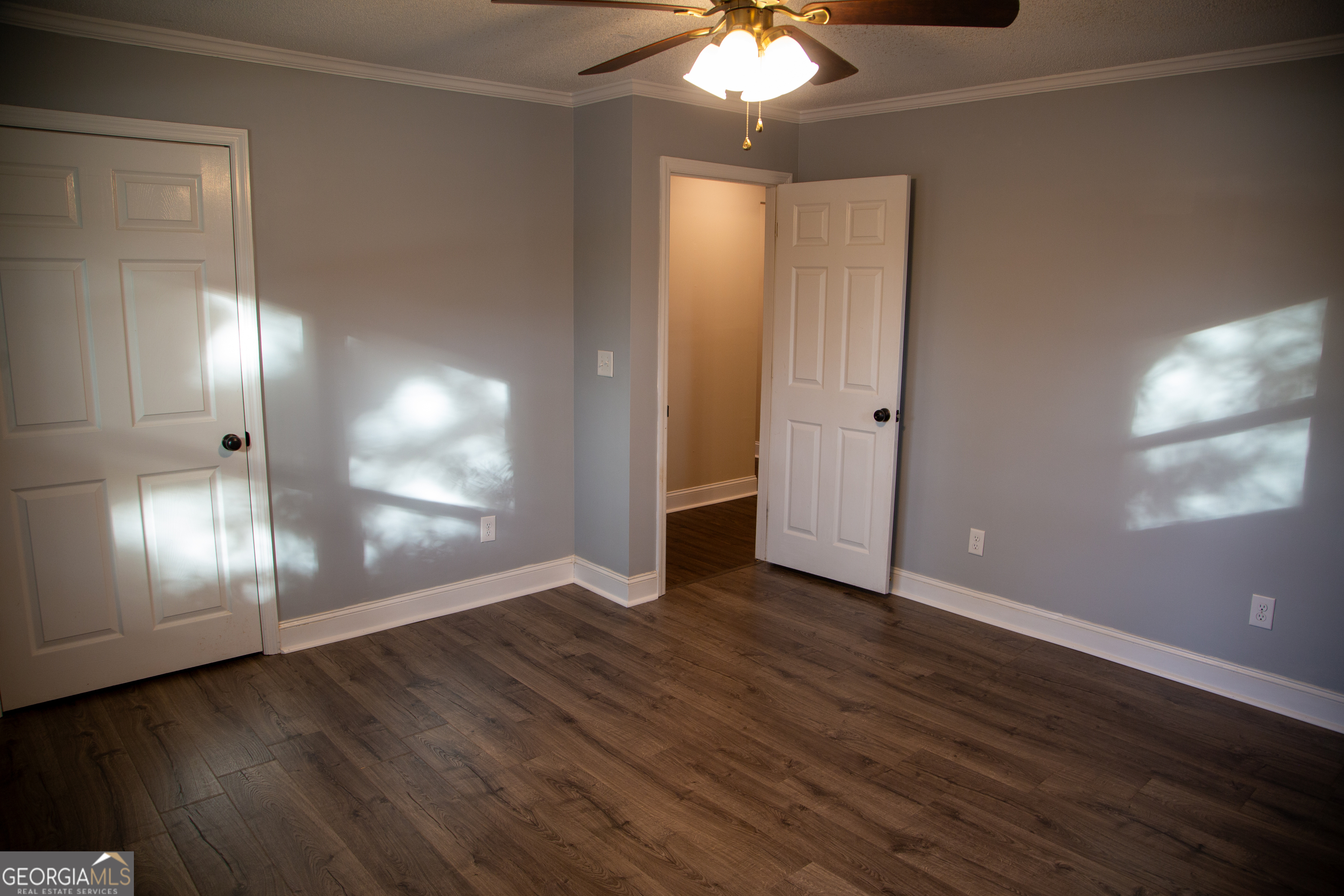 307 South Duke Street LaFayette, GA 30728 - Photo 20 of 23 an empty room with wooden floor chandelier fan and windows