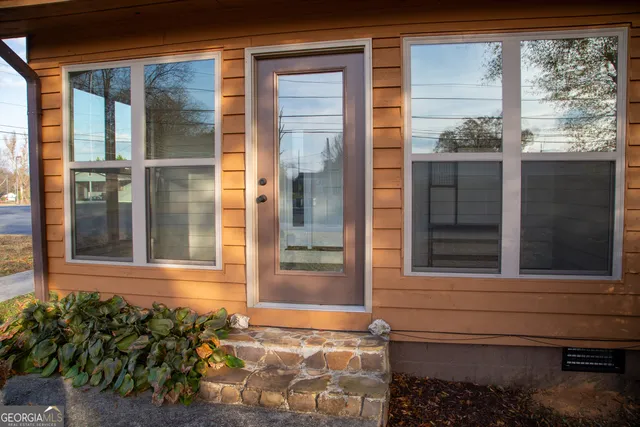 a view of a door of a house with a small yard