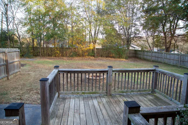 a view of balcony with wooden floor and fence