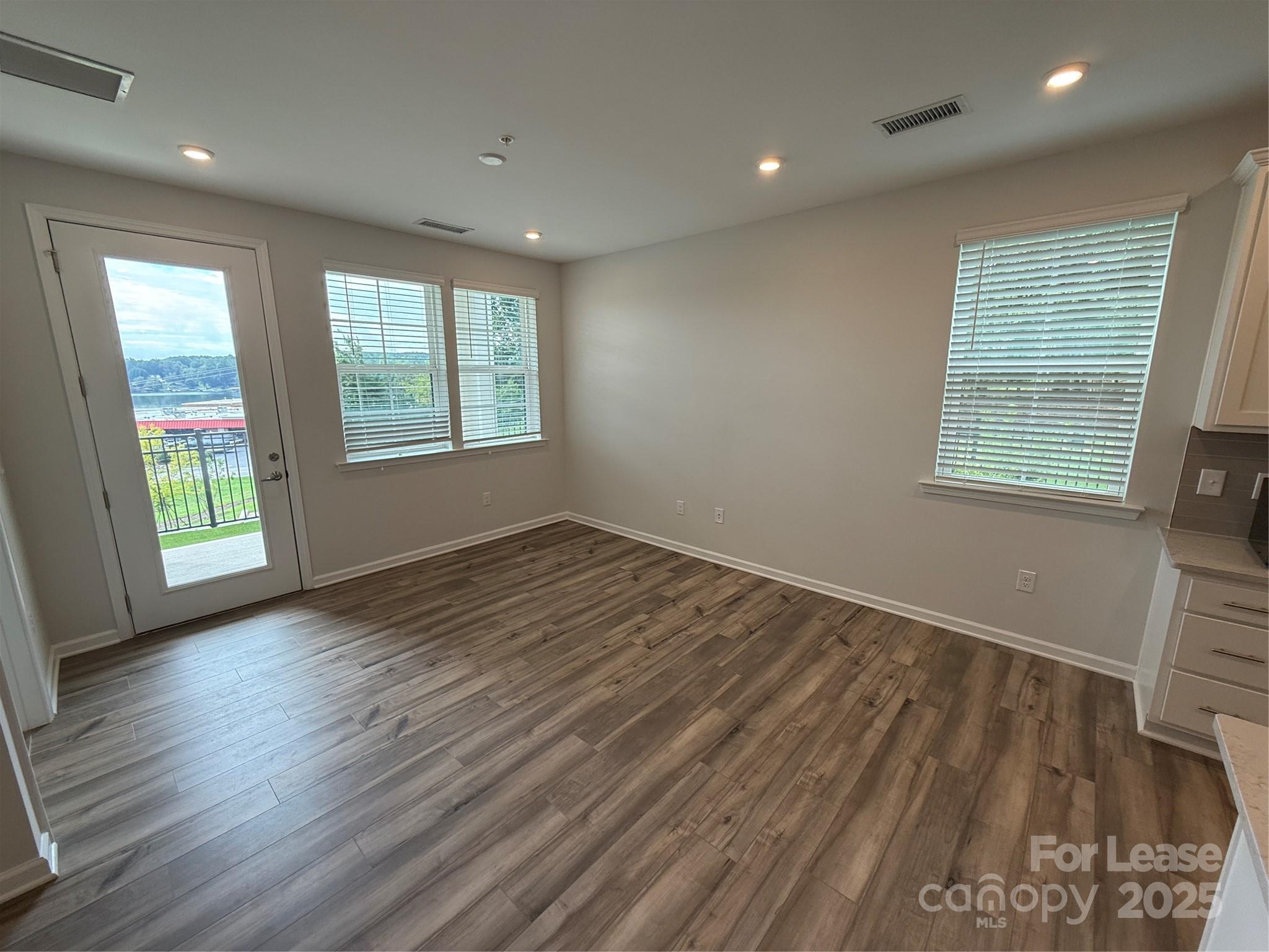 4455 Reed Crk Drive, Unit 101 Sherrills Ford, NC 28673 - Photo 11 of 34 an empty room with wooden floor and windows