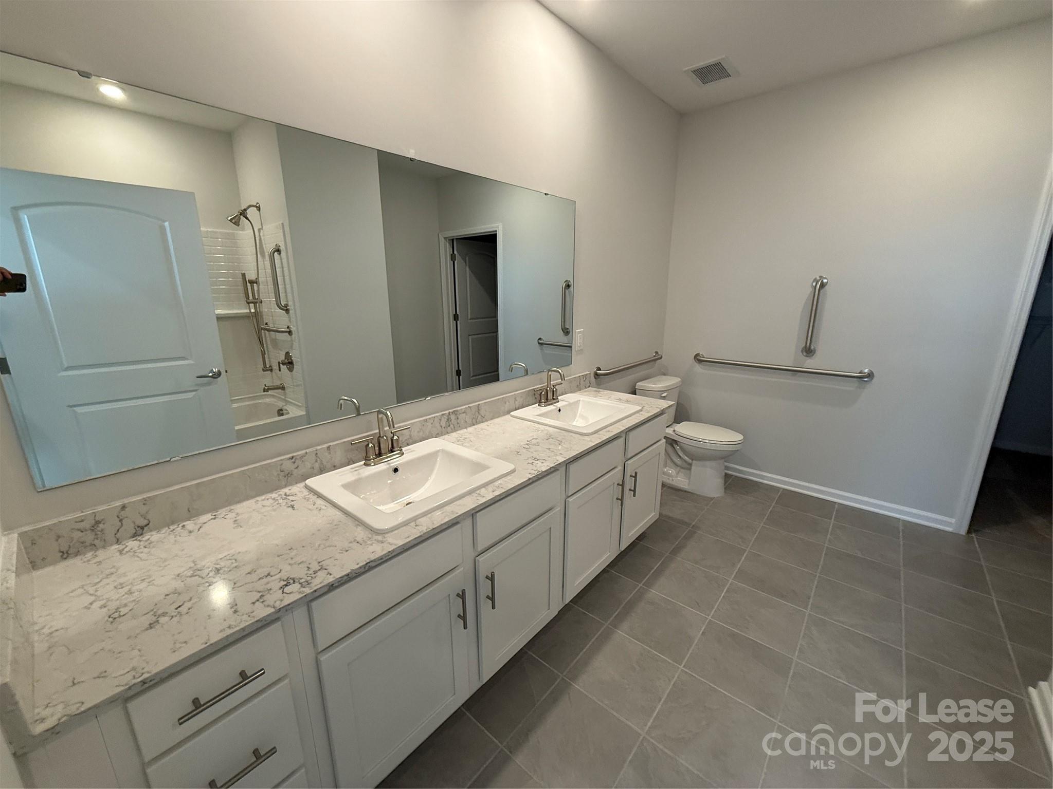 4455 Reed Crk Drive, Unit 101 Sherrills Ford, NC 28673 - Photo 14 of 34 a bathroom with a granite countertop sink mirror and toilet